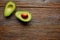 Avocado cut on aged wood table board