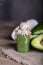 Avocado facial scrub on a wooden surface.