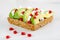 Avocado with Feta, pomegranate on sunflower seeds bread sandwich