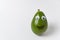 Avocado with Googly eyes and painted smile on white background. Avocado character