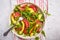 Avocado and grapefruit salad in a white plate on a white background.