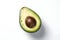 Avocado on a green background. The green background adds contrast and references the fruit\\\'s natural surroundings.