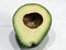 Avocado halved on a wooden table