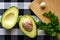 Avocado halves, garlic and parsley are on the cutting Board. Proper healthy nutrition, weight loss, diet