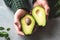 Avocado halves in male hands