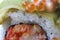 Avocado nigiri sushi roll with orange flying fish eggs