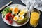 Avocado and poached egg toasts, salad and orange juice