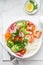 Avocado, prawn, cucumber, tomato, radish, carrot and rice salad bowl. Healthy food