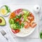 Avocado, prawn, cucumber, tomato, radish, carrot and rice salad bowl. Healthy food