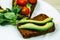 Avocado sandwich: rye dark bread made with fresh sliced avocados with Corn mache salad