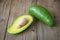 Avocado sliced half on wooden - Fruits healthy food concept