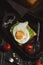 Avocado smeared on toast, top fried egg, rustic style, top view. Toned photo.