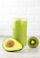 Avocado smoothie on a white background. Green smoothie with avocado, kiwi, banana on white background. Selective focus.