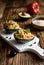 Avocado stuffed with quinoa, green peas, tomato, olives, bell pepper and parsley