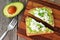 Avocado toast with egg whites and pea shoots, overhead view