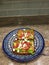 Avocado toast on polish pottery sitting on a granite countertop