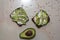 Avocado toast with seeds on marble vintage background. Slices of avocado on the wholemeal bread with sunflower and flax seeds.