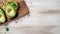 Avocado toast with seeds on wooden background. Top view, copy space.