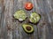 Avocado toast with seeds on wooden vintage background. Slices of avocado on the wholemeal bread with sunflower and flax seeds.