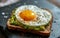 Avocado toast with a sunny side up egg on top