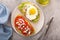 Avocado toasts with fried egg and heirloom tomatoes