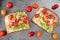 Avocado toasts with hummus and tomatoes, overhead view