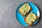 Avocado toasts on whole grain bread, mashed avocado with sesame seeds, healthy eating concept, top view