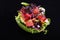 Avocado with tuna and sesame seeds on a black background