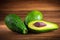 Avocado on vintage wooden table. Raw fruits healthy green food. Avocados banner or diet concept