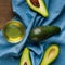 Avocadoes on blue
