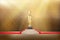 Award trophy on a pedestal with a red carpet on a gold background. vector