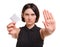 Aware young woman showing a condom or contraceptive isolated on a white background. Healthy lifestyle. Safe sex concept.