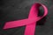 Awareness Pink Ribbon On Black Background. Breast Cancer Awareness Symbol and Month Of Solidarity. 3d rendering