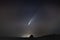 Awe-inspiring shot of a comet streaking across a star-studded night sky