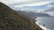 Awesome beautiful AERIAL view of a car on a dirt mountain road over the Atlantic Ocean on Tenerife, Canary Islands