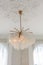 awesome beautiful chandelier in an old style in a gentle cozy bright apartment with huge panoramic windows with sunlight