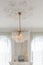 awesome beautiful chandelier in an old style in a gentle cozy bright apartment with huge panoramic windows with sunlight