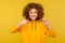 Awesome bitcoin! Portrait of happy satisfied curly-haired woman in urban style hoodie showing thumbs up