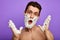 Awesome crazy shirtless man with open mouth and white face and hands