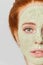 Awesome ginger girl with cosmetic green mask on face