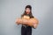 awesome girl holding big and small pumpkins on a gray background.