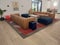 Awesome Interior design having sofa set, wall art, plant, carpet, wooden flooring and couches made good ambience and fresh mood.