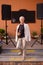 Awesome mature woman is standing on the street stage