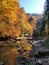 Awesome ravine with small river in scenic fairytale colorful autumn landscape