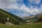 Awesome summer panorama of South Tyrolean valley with wooden capital and rainbow