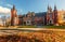 Awesome sunny Landscape, Perfect Sky over the Fairytale castle with Fall Autumn Leafes on foreground. Amazing view on Palace in