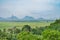 Awesome top view of greenery field with a electric transmission pole with greenery forest & mountain view.