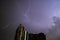 Awesome View of Real Lightning Striking on Night Sky over the High Building