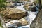 Awesome view of waterfall passing through a mountain big rock near by water reservoir.