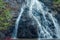 Awesome view of waterfall passing through a mountain big rock near by water reservoir. Dudhsagar falls in lake close up view